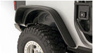 Close up of bushwacker 07-18 jeep wrangler flat style fender flares with tire and tire guard