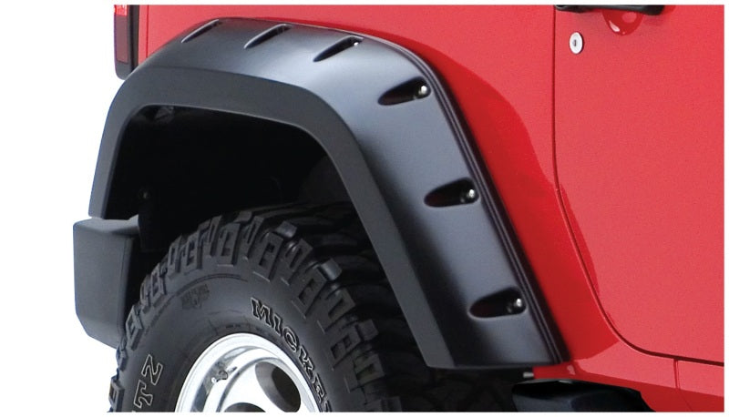 Red jeep wrangler with black tire cover - bushwacker pocket style fender flares