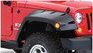 Red jeep wrangler with black bumper and tire - bushwacker max pocket style fender flares