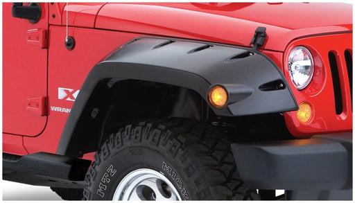 Red jeep wrangler with black bumper and tire - bushwacker max pocket style fender flares