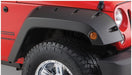 Red jeep wrangler with black pocket style fender flares by bushwacker