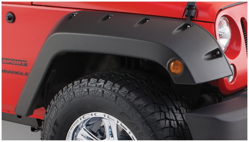 Red jeep wrangler with black pocket style fender flares by bushwacker