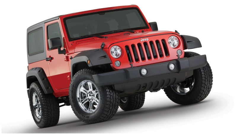 Red jeep wrangler with pocket style fender flares on white surface