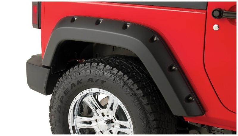 Red jeep wrangler with black bumper pocket style fender flares