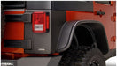 Close up of red jeep wrangler with black bumper - bushwacker trail armor rear corners