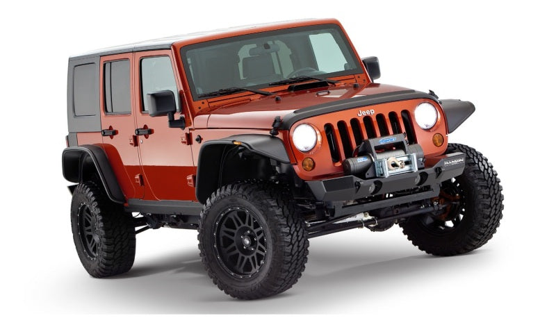 Red jeep wrangler unlimited with flat style fender flares and black accents