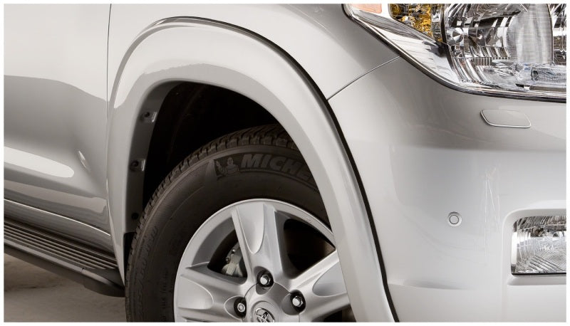 White toyota land cruiser with bushwacker fender flares and black tire cover