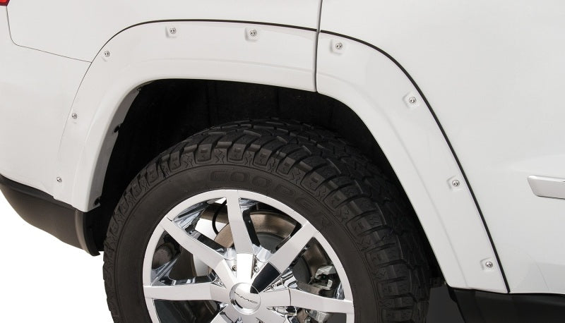 White truck with black tire featuring bushwacker pocket style fender flares for jeep grand cherokee