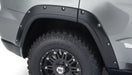 Black truck with tire cover - bushwacker pocket style fender flares for jeep grand cherokee