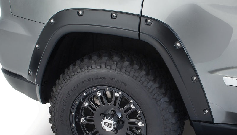 Black truck with tire cover - bushwacker pocket style fender flares for jeep grand cherokee