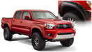 Red toyota tacoma pocket style fender flares with black bumper on white background