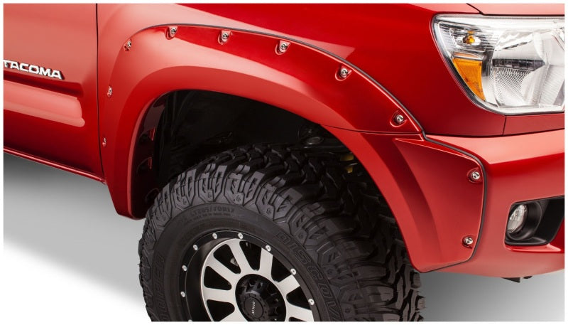 Red truck with black tire cover - bushwacker pocket style fender flares for toyota tacoma