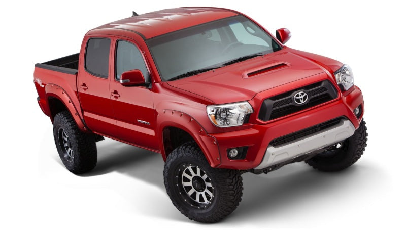 Red toyota tacoma with bushwacker pocket style fender flares