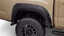 Tan colored toyota tacoma front end with pocket style fender flares in black