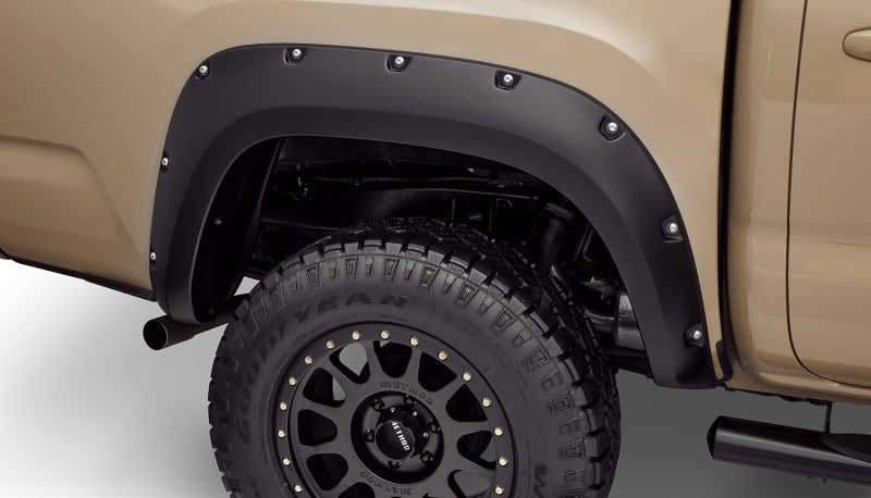 Tan colored toyota tacoma front end with pocket style fender flares in black