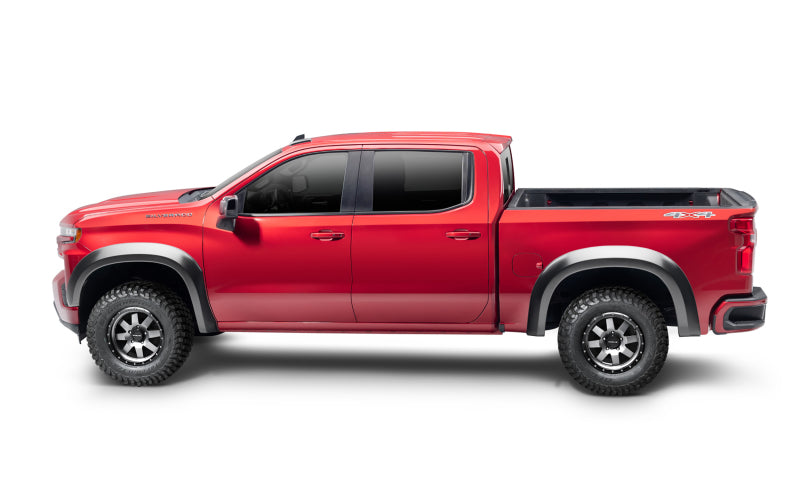 Red truck parked with toyota tacoma pocket style flares on white background