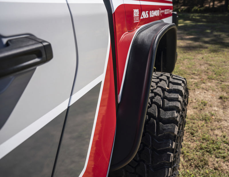Front end of red and white truck with flat style fender flares by bushwacker