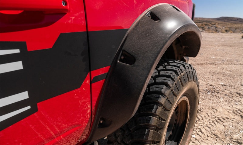 Red truck with black tire cover featuring bushwacker 2021+ ford bronco 4-door pocket style fender flares