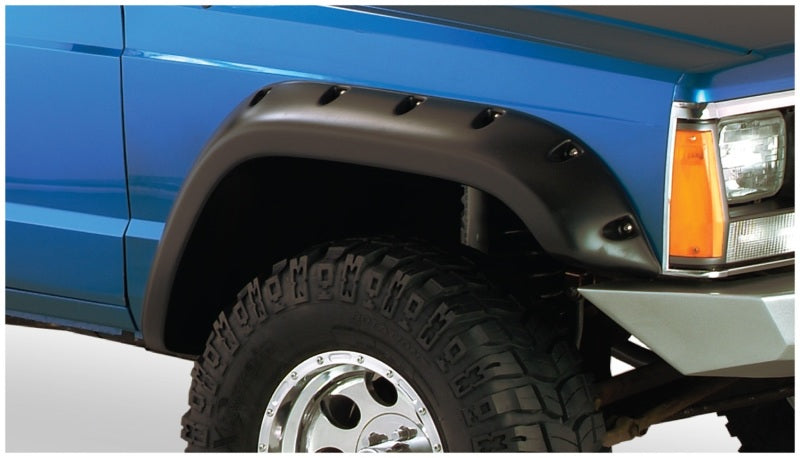 Blue truck with black and white bumpers - bushwacker jeep cherokee fender flares