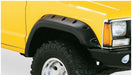 Yellow truck with black bumper against white background - bushwacker jeep cherokee cutout style flares in black