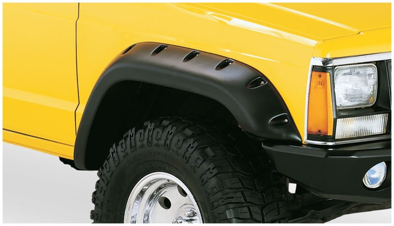 Yellow truck with black bumper against white background - bushwacker jeep cherokee cutout style flares in black