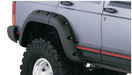 Black jeep cherokee with white tire cover - bushwacker fender flares for 4-door sport utility vehicle