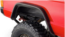 Red truck with tire - bushwacker 84-01 jeep cherokee flat style fender flares in black