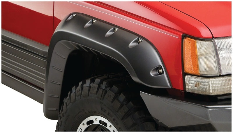 Red truck with black bumper on white background - bushwacker jeep grand cherokee fender flares 4pc in black