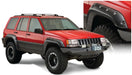 Red jeep grand cherokee with black bumper showcased in bushwacker fender flares - black