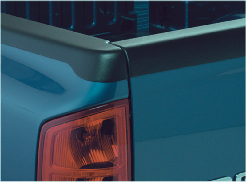 Close up of the tail light on blue truck with bushwacker 95-04 toyota tacoma fleetside bed rail caps