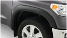 Close-up of front bumper plate on gray toyota tacoma fleetside with bushwacker fender flares