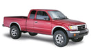 Red toyota tacoma fleetside fender flares truck against white backdrop