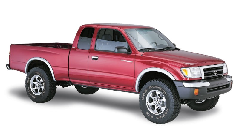 Red toyota tacoma fleetside fender flares truck against white backdrop