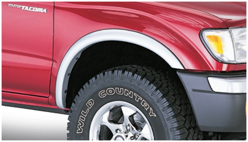 Red toyota tacoma fleetside fender flares with white lettering on truck