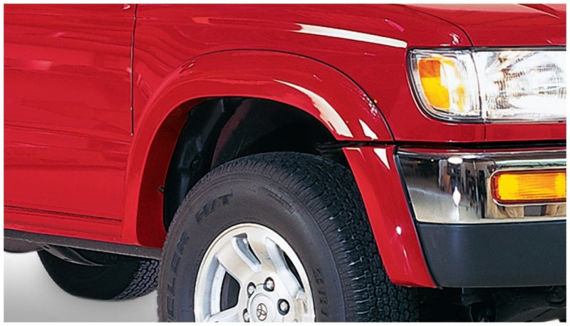 Red truck with white background, bushwacker toyota 4runner extend-a-fender style flares