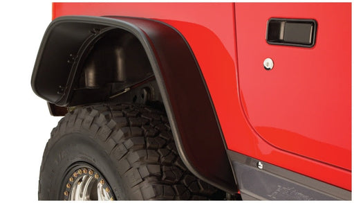 Red jeep with black flat style fender flares by bushwacker