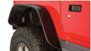 Red jeep with black flat style fender flares by bushwacker