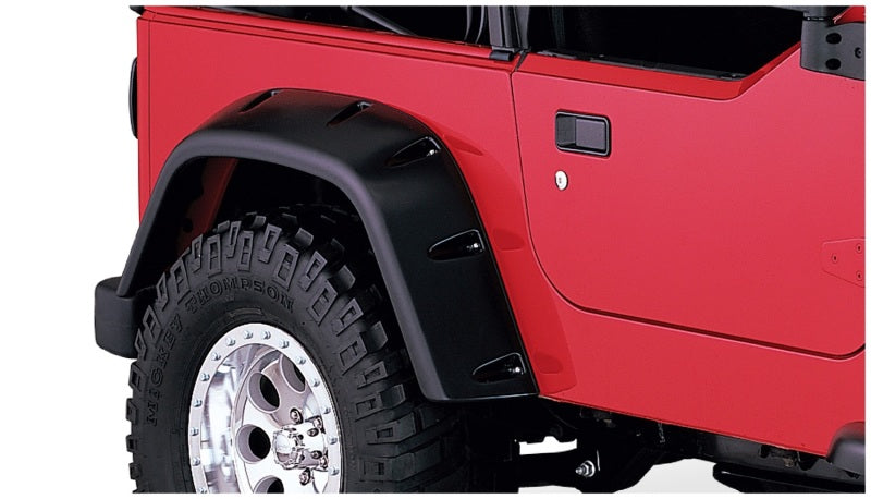 Red jeep with black tire cover - bushwacker 97-06 jeep tj pocket style fender flares