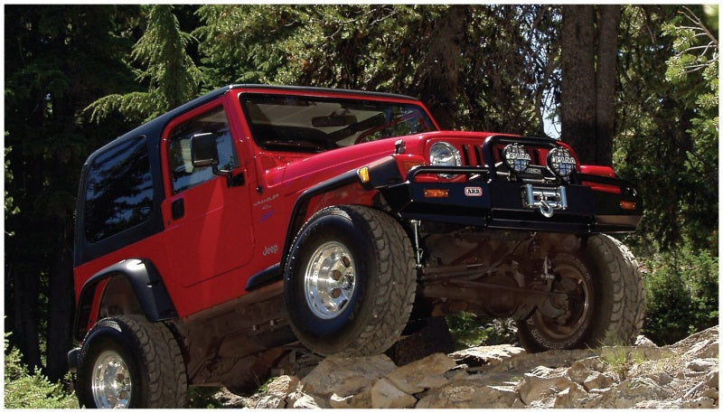 Red jeep wrangler driving on rocky trail with pocket style fender flares