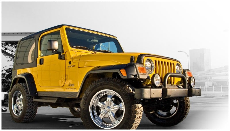 Yellow and black jeep tj with pocket style fender flares by bushwacker