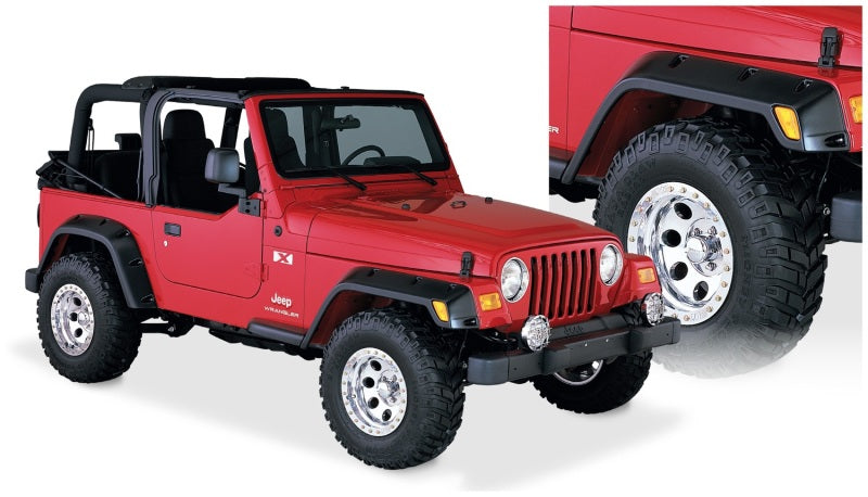 Red jeep with pocket style fender flares, black top, and white wheels - bushwacker 97-06 jeep tj 4pc