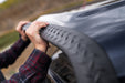 Man fixing front bumper of jeep wrangler with bushwacker trail armor in black