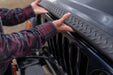 Man installing bushwacker jeep wrangler trail armor side panel on a truck