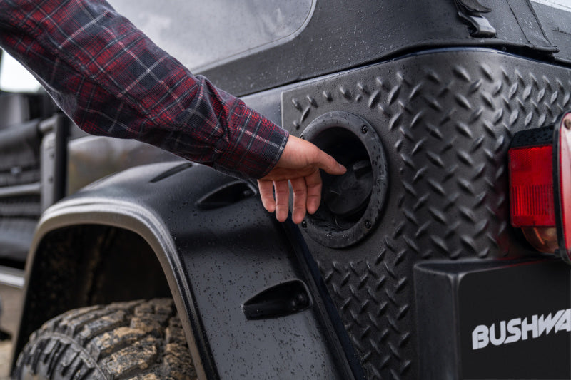 Man installing tire on jeep wrangler trail armor product