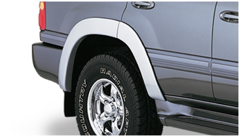 Toyota land cruiser silver suv with white tire cover - bushwacker oe style fender flares