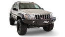 Bushwacker 99-04 jeep grand cherokee cutout style flares 4pc - black fender flares on white background with big tire