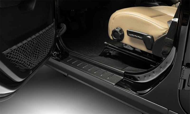 Interior of a jeep wrangler jl with door open - bushwacker trail armor rocker panel and sill plate cover in black