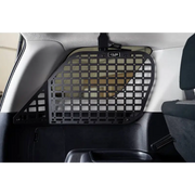 Dog sitting in back seat of Toyota 4Runner with molle panels installed