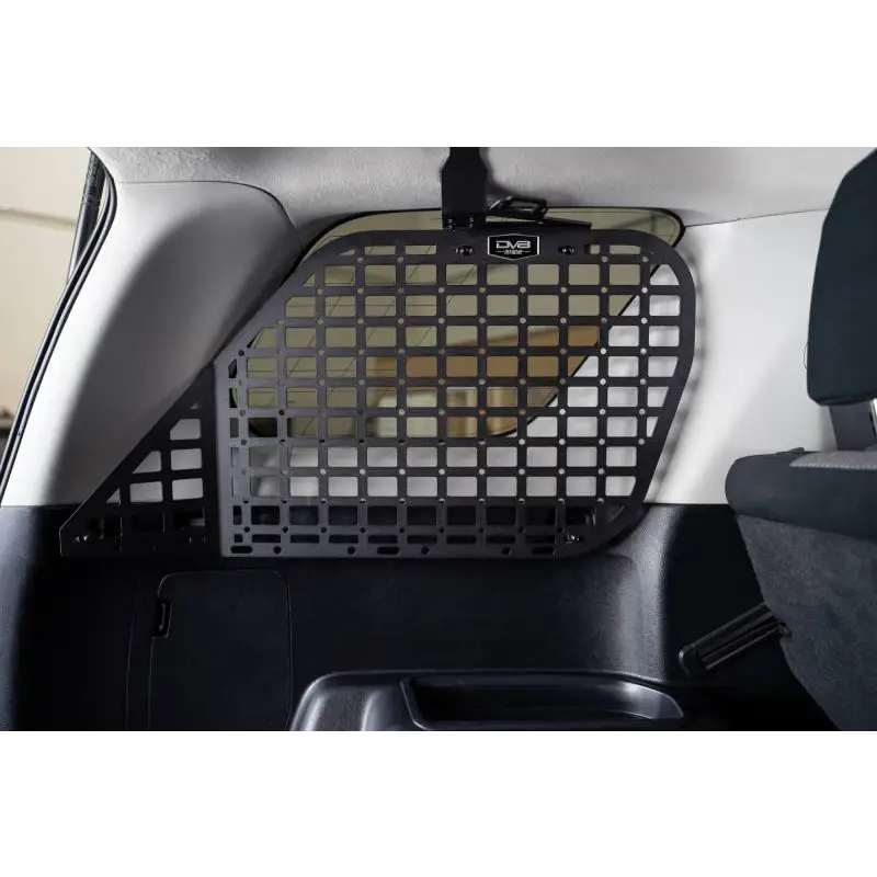 Dog sitting in back seat of Toyota 4Runner with molle panels installed