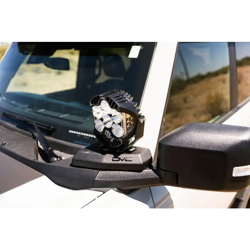 DV8 21-22 Ford Bronco A-Pillar Pod Light Mounts showcasing front view mirror of white car